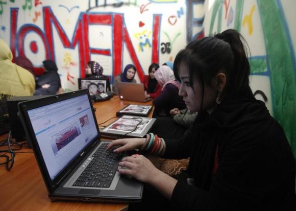 Afghan girls work at a first Internet cafe for women in Kabul